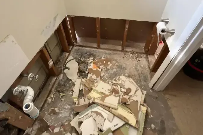 A bathroom stripped back to the studs after a sewage backup cleanup